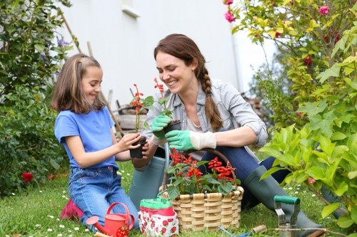 Gardener in Poplar following safe working practices in a maintained garden